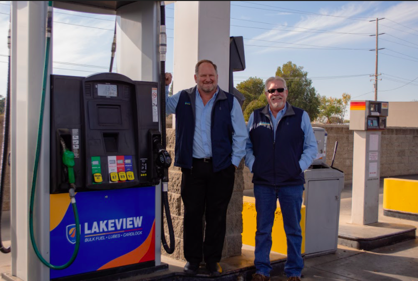 Two men standing beside a Pacific Pride fuel pump branded with Lakeview Energy. As a franchisee of Pacific Pride, we offer our customers the ability to operate your fleet at top efficiency with Fleet Fuel Cardlock.