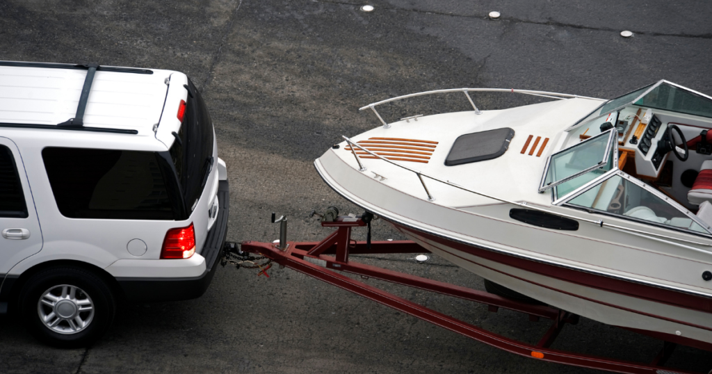SUV pulling boat and trailer.