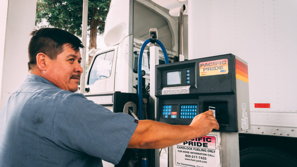 Man pumping fuel at a Pacific Pride pump using his Fleet Fuel card.