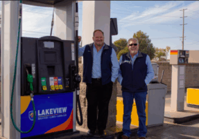 Two men standing beside a Pacific Pride fuel pump branded with Lakeview Energy. As a franchisee of Pacific Pride, we offer our customers the ability to operate your fleet at top efficiency with Fleet Fuel Cardlock.