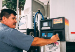 Man pumping fuel at a Pacific Pride pump using his Fleet Fuel card.